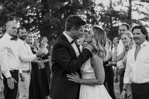 Black and white photos showing joyful dancing and celebration at an outdoor wedding reception.