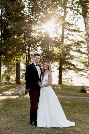 Romantic sunset wedding photos captured in a scenic wooded hillside location.