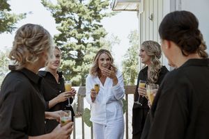 Wedding guests mingling and socializing at an outdoor venue.