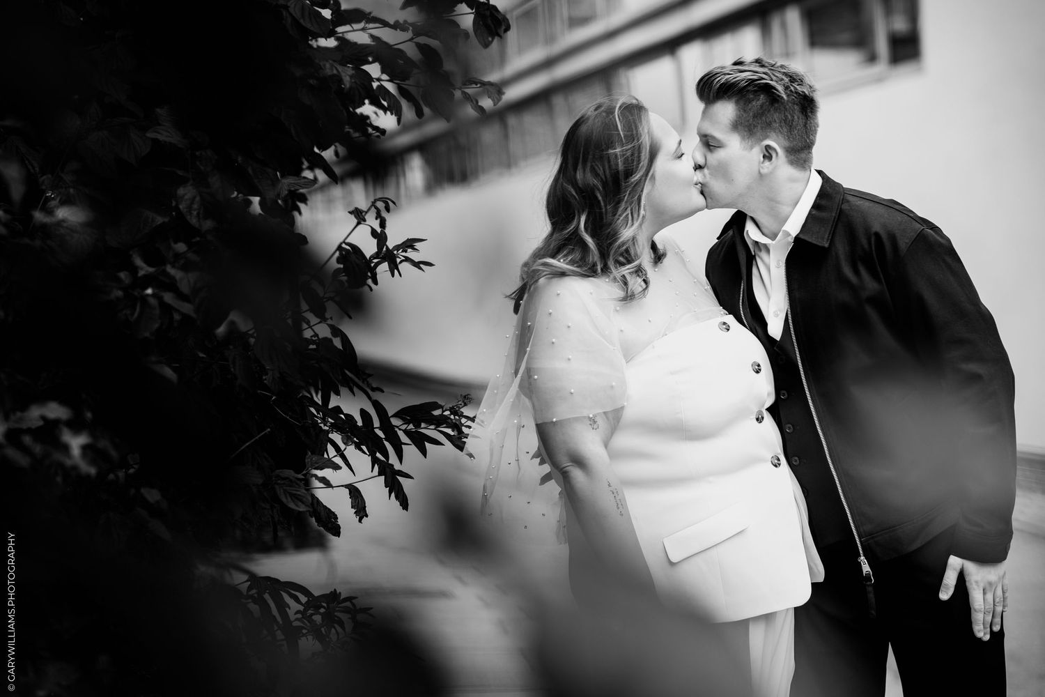 A romantic black and white wedding photography sequence showing tender moments between the bride and groom.