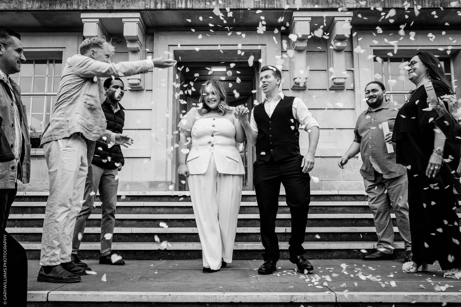 A black and white photo collage showing people dancing and celebrating at what appears to be a vintage wedding reception.