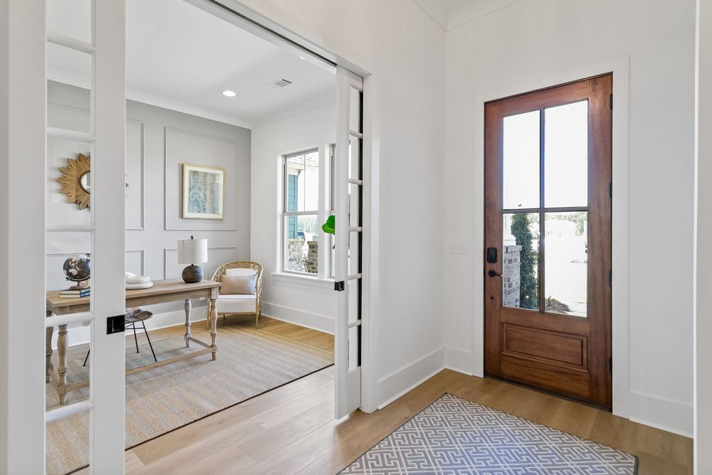 Modern white hallway with wooden door and recessed lighting showcases clean lines and minimalist design throughout.