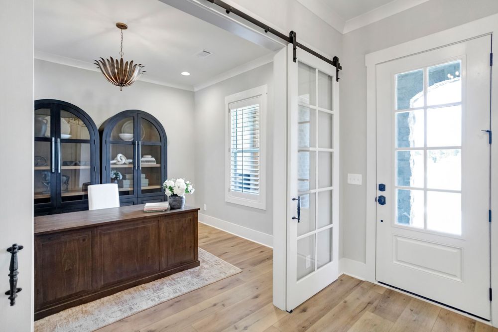 A collage of modern farmhouse interior design elements showing white walls, dark hardware, and wood accents.