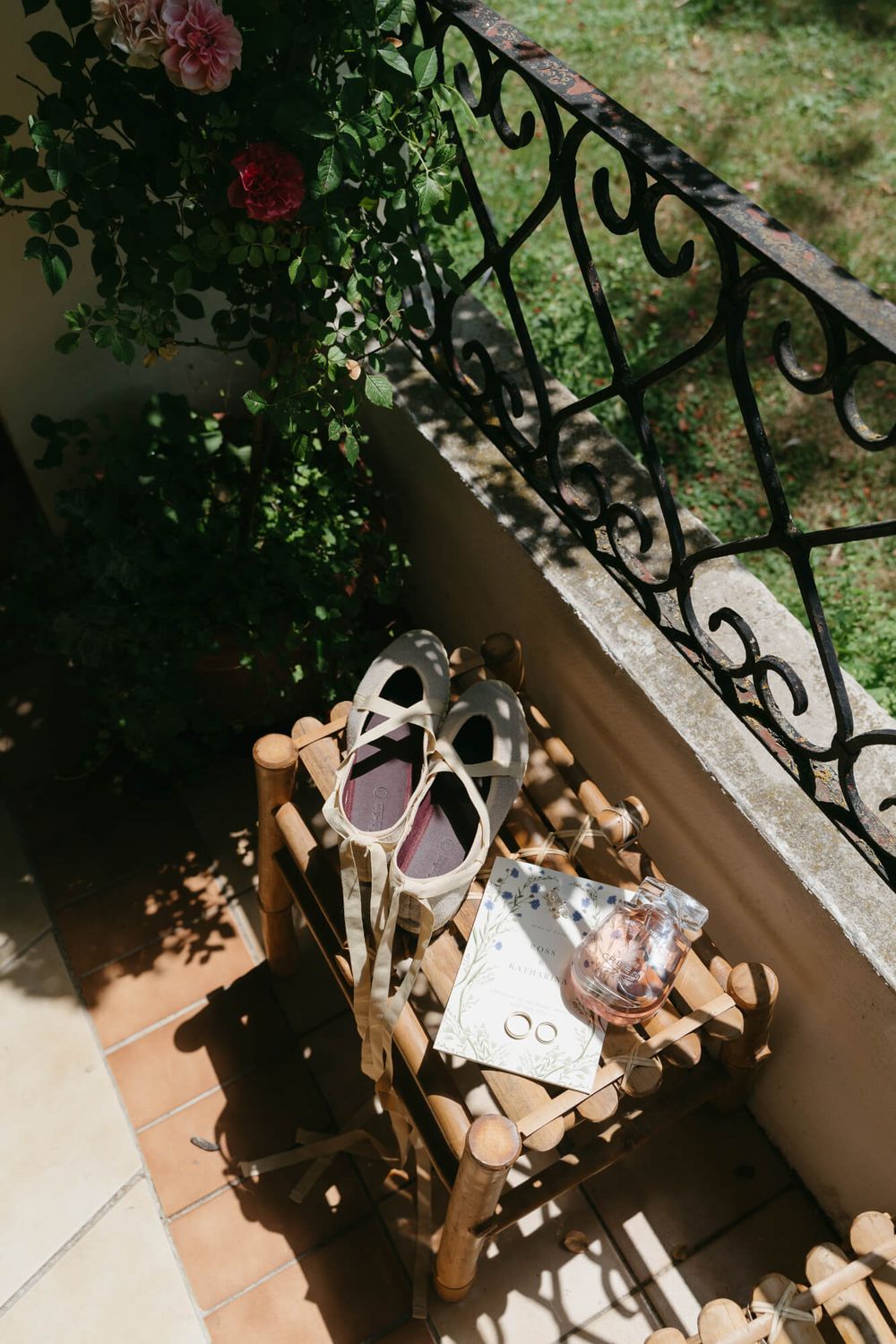 Timelapse sequence showing shadows moving across terracotta tiles and wrought iron railings on a sunny patio.