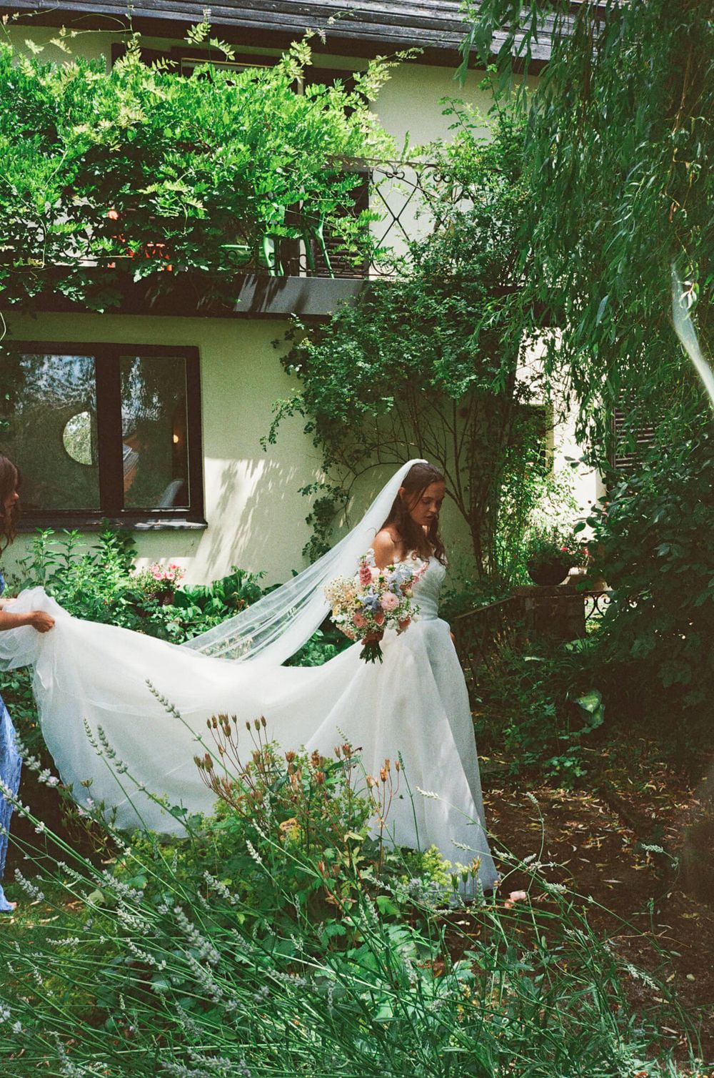 A series of ethereal photos showing flowing white fabric moving through a lush garden setting.
