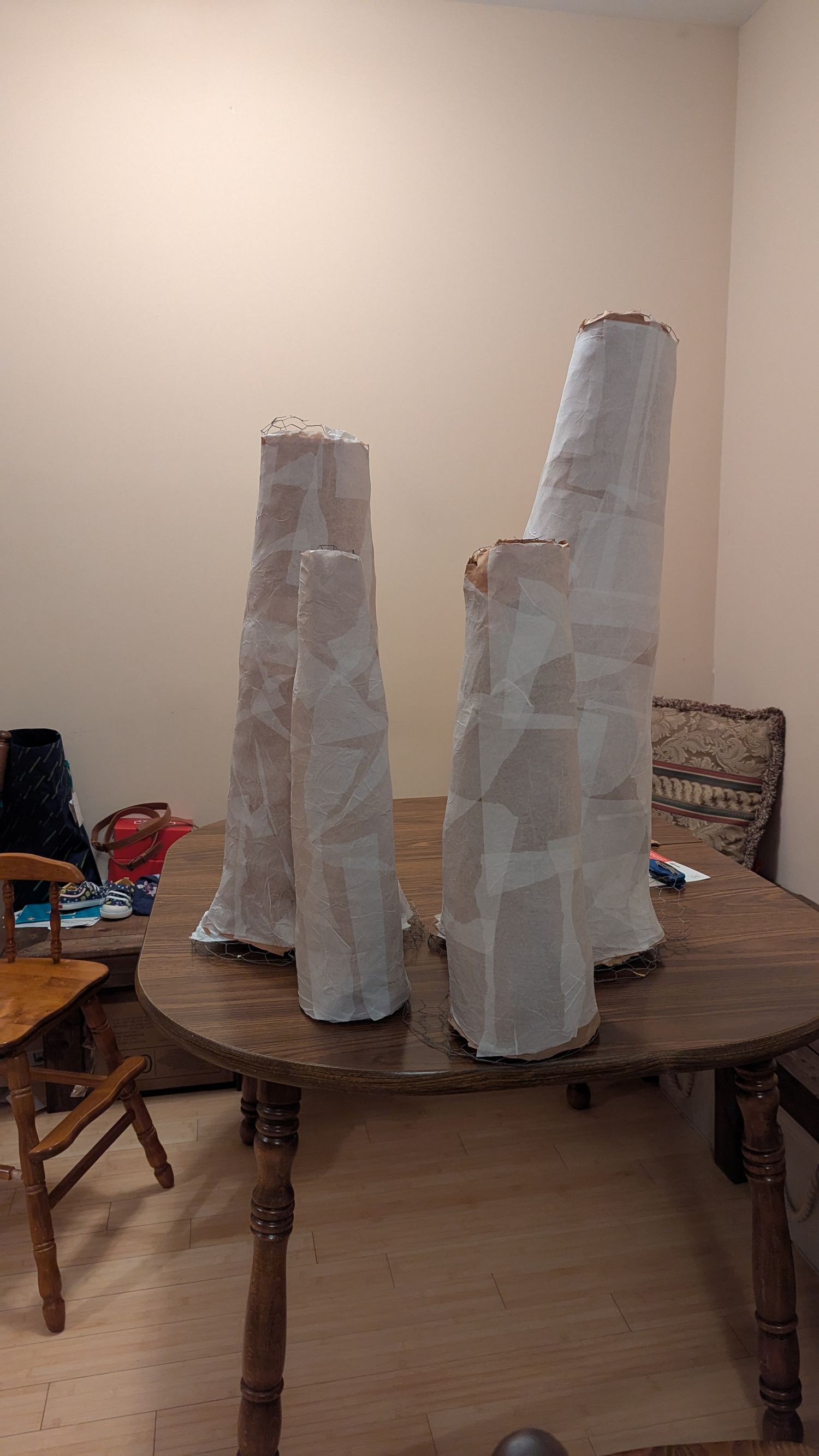 4 stems sit ready to be painted on a table.