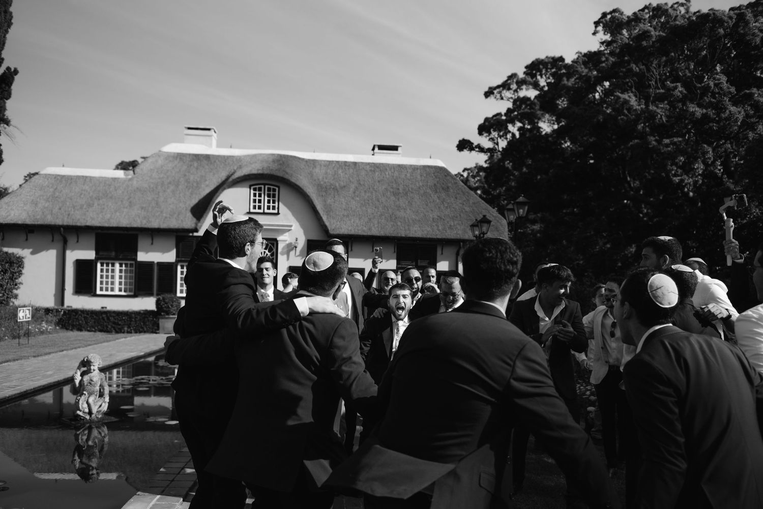 A sequence of black and white photographs showing people gathered outside a building with a helicopter visible in the scene.