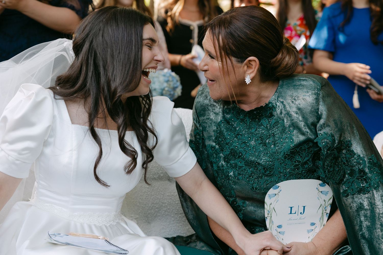 A group of people in formal attire sharing joyful moments at a celebration event.