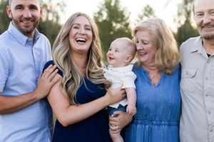Group laughs together during casual outdoor family photo session in natural lighting. Sussex County NJ Photographer