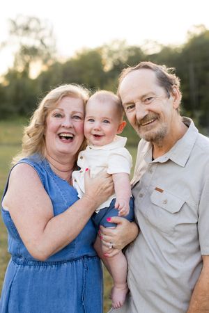 Family sharing joyful moments together in a sunny outdoor setting.