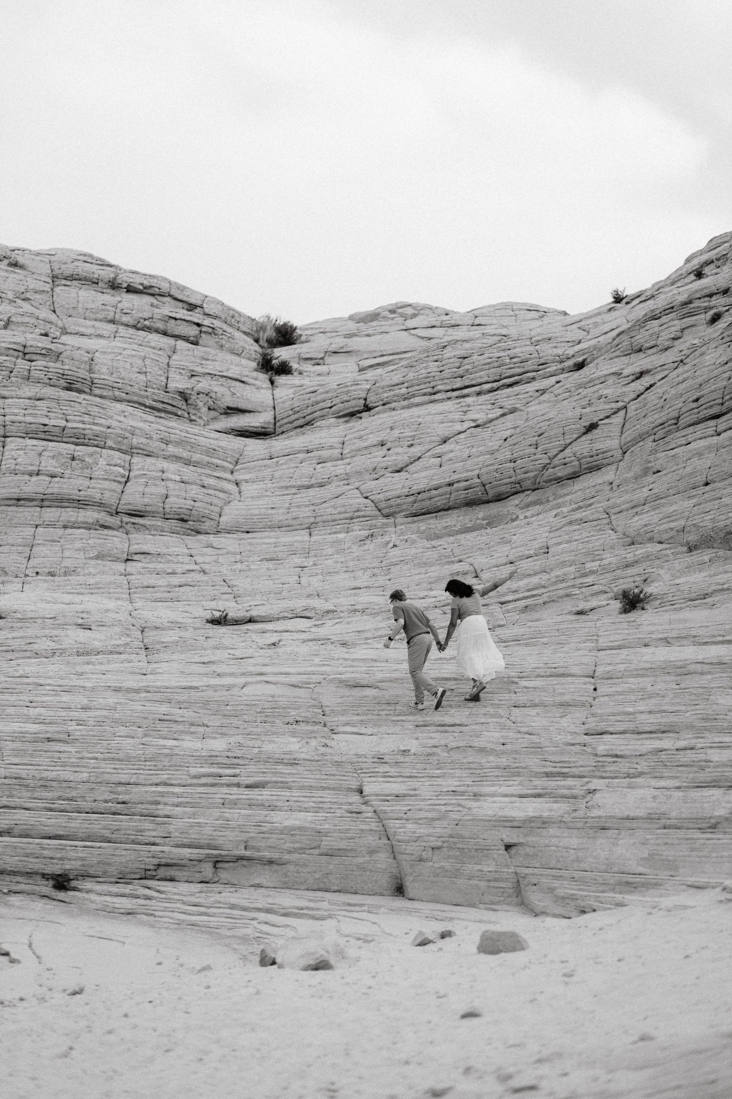 A series of four black and white photographs showing Native American teepees against a backdrop of layered rock formations.