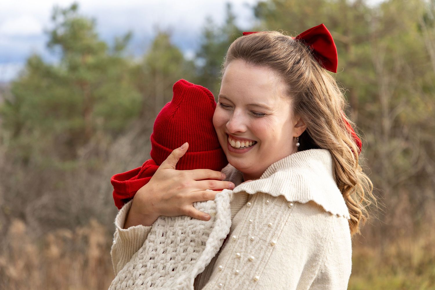 A mom holding her young baby boy with him cuddled close