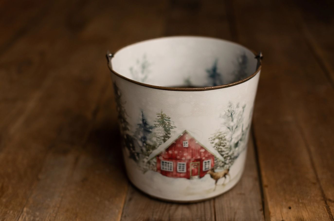 Bucket hugger featuring a red barn scene with falling snow