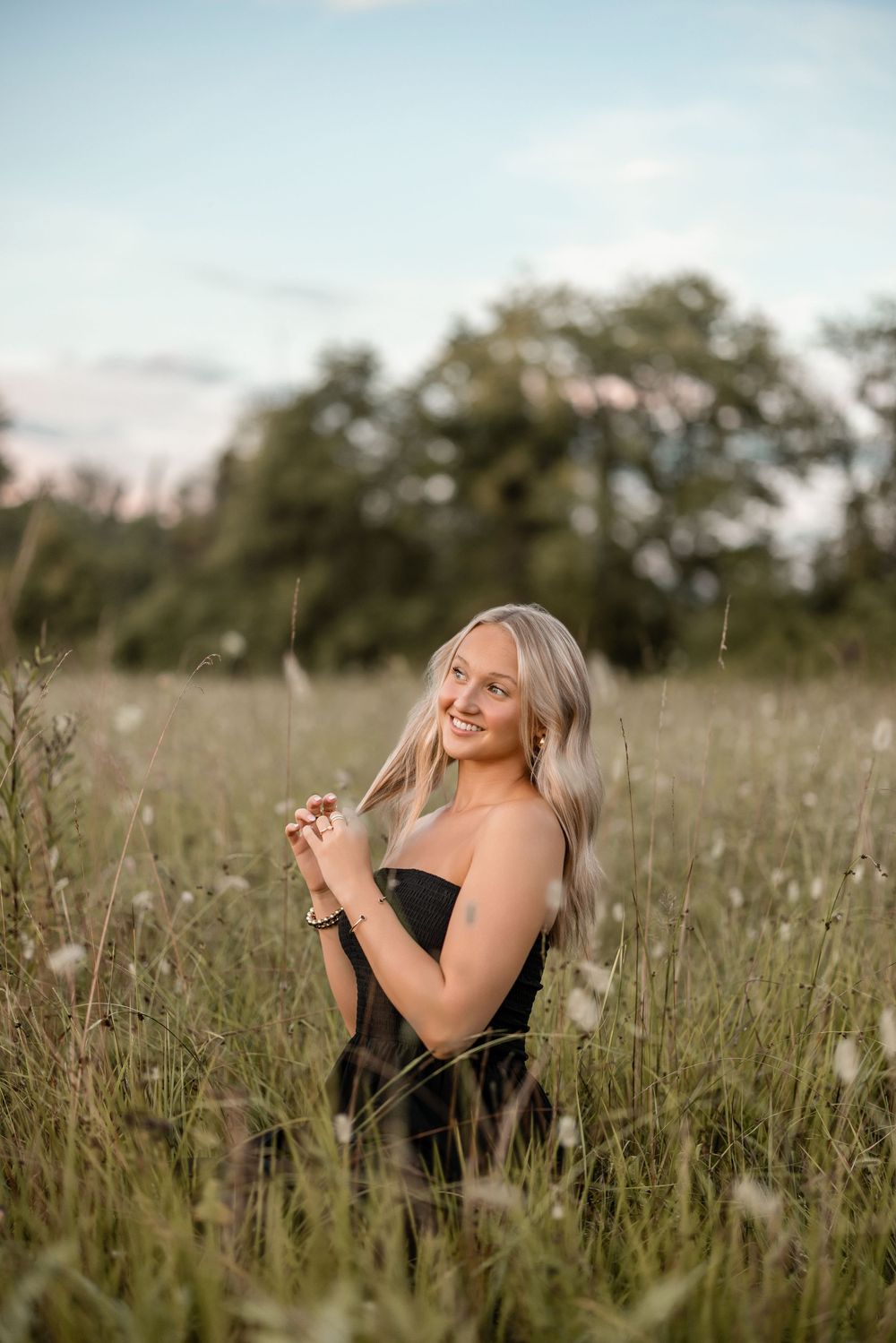 Natural lifestyle photoshoot in a wildflower meadow showing joyful expressions and carefree movements.