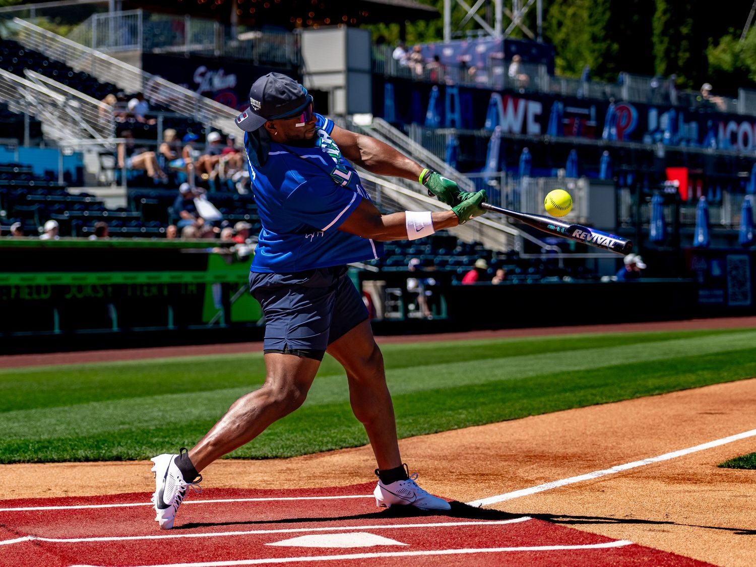 Baseball player swinging a bat during a game at an outdoor stadium.