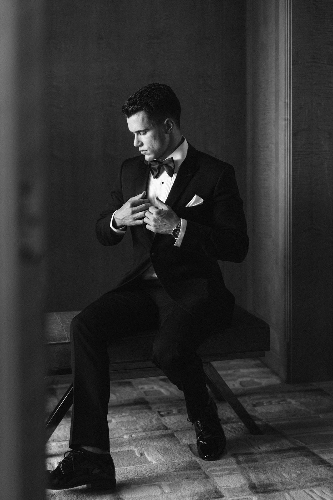 Black and white portrait series showing figure in suit sitting in dramatic shadows by window with contemplative poses.