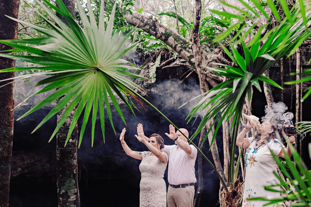 A lush tropical garden setting with palm fronds and tropical plants creating a natural outdoor environment.