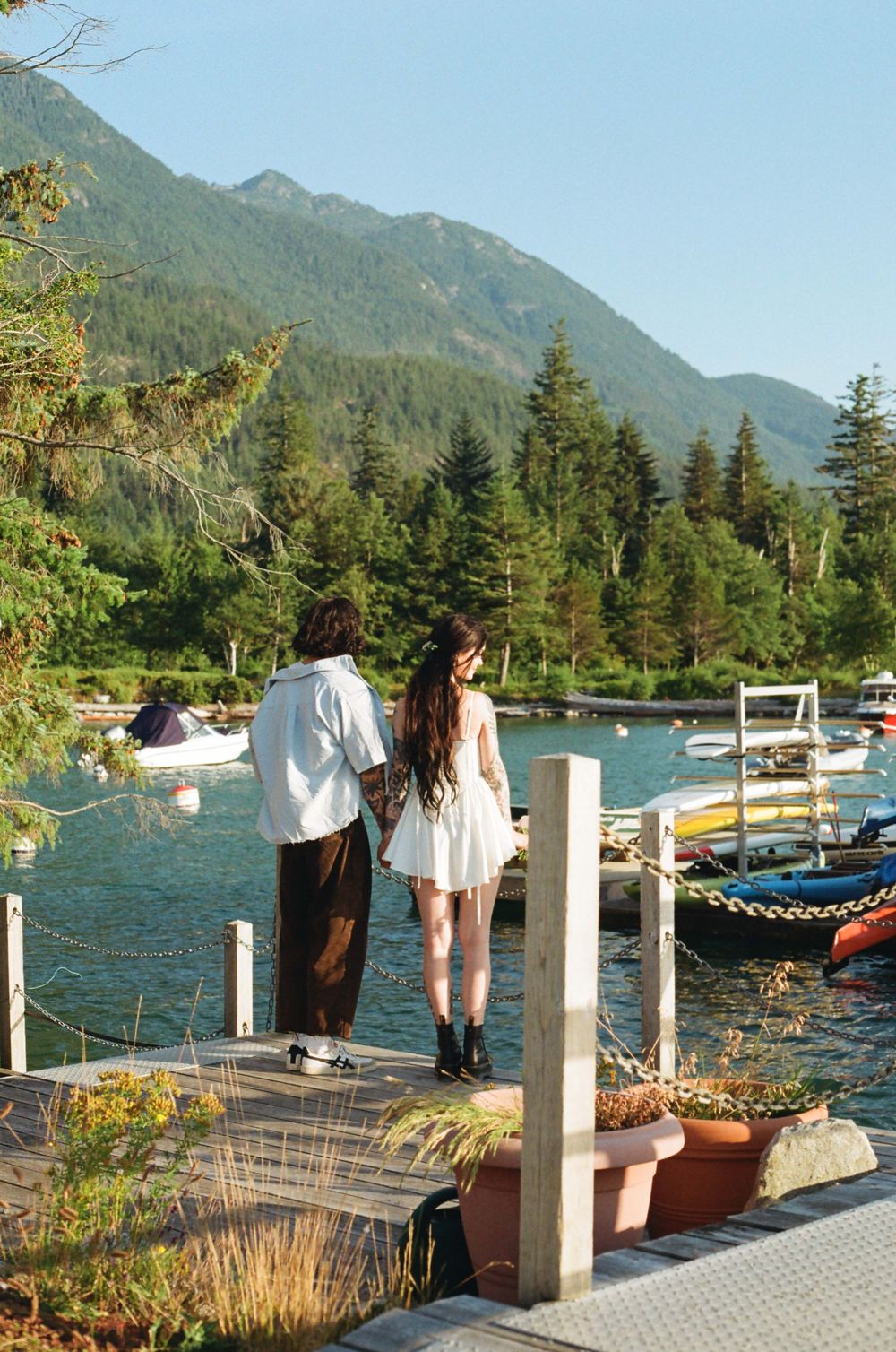 Scenic dock overlooking mountains and water on a clear summer day.