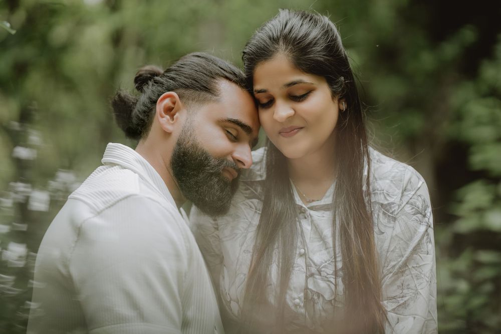 A romantic couple in wedding attire share intimate moments together in a lush garden setting.
