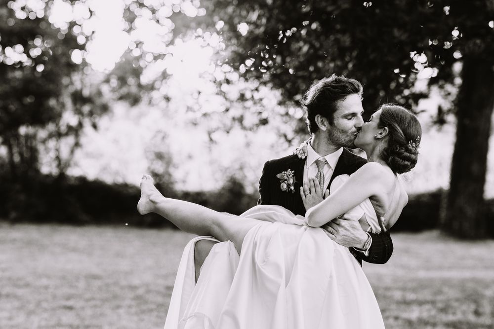 Three black and white photos showing silhouettes of a couple dancing gracefully in a garden setting.