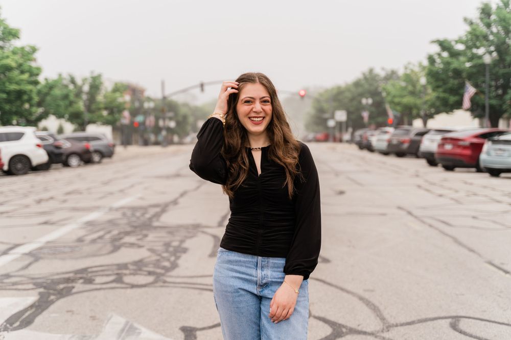 Casual street style photo in parking lot with classic black and denim outfit combination.