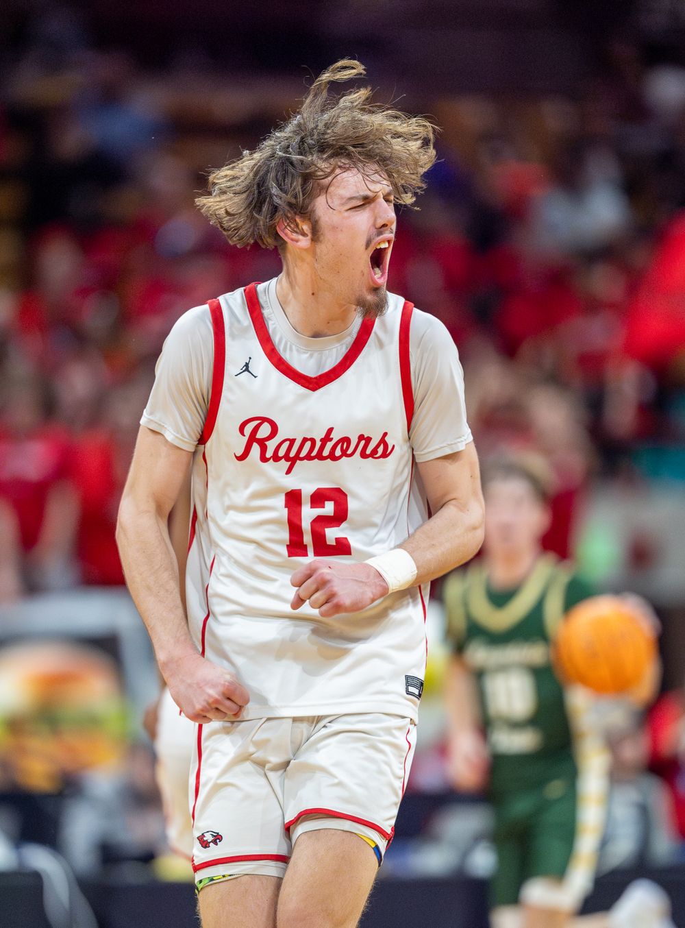 Basketball player shows intense emotion during game celebration.