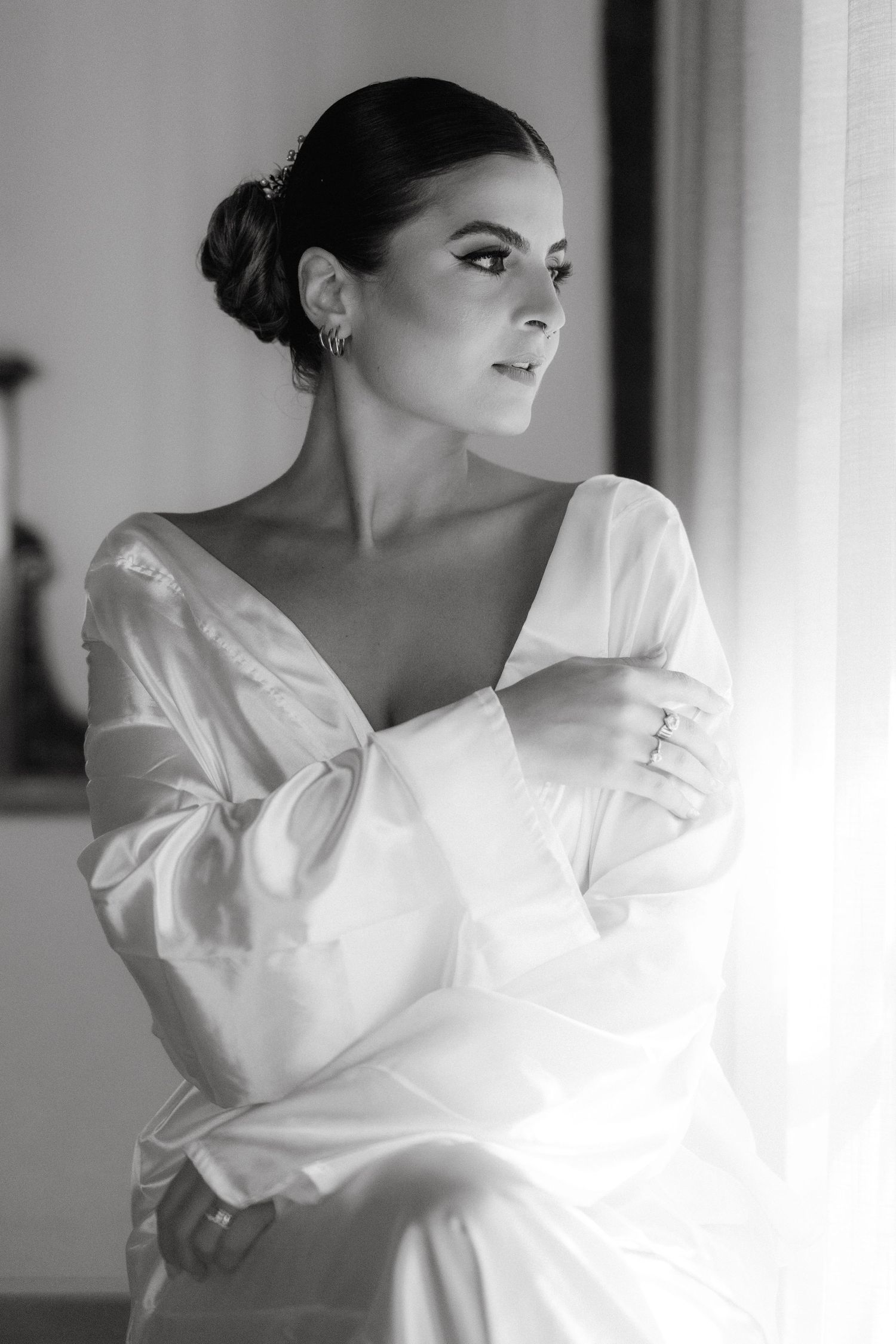 Ethereal black and white portrait of someone wearing an elegant white wedding dress.
