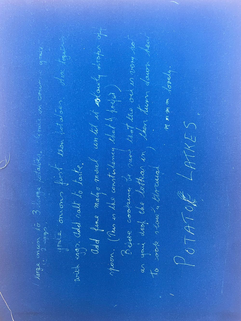 Handwritten mathematical equations and formulas written in white text against a bright blue background.
