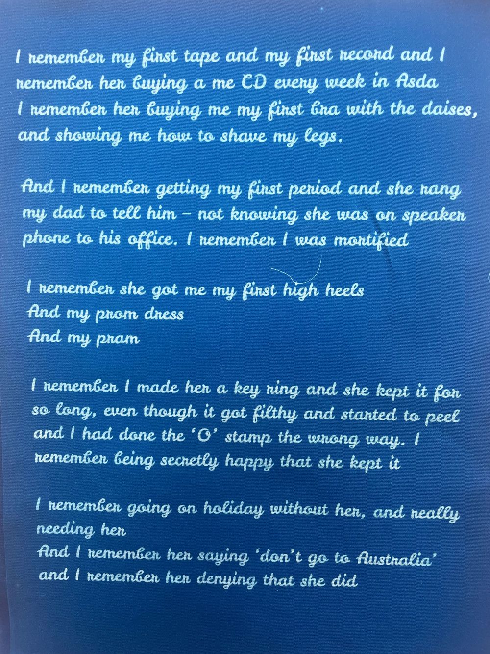 Handwritten text in white letters on a dark blue background shows personal memories and reflections.
