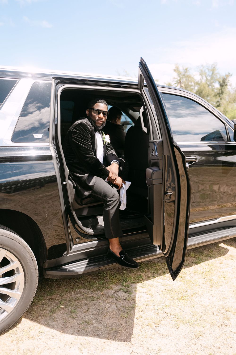 Sequence of photos showing someone exiting a black luxury car on a dirt surface.