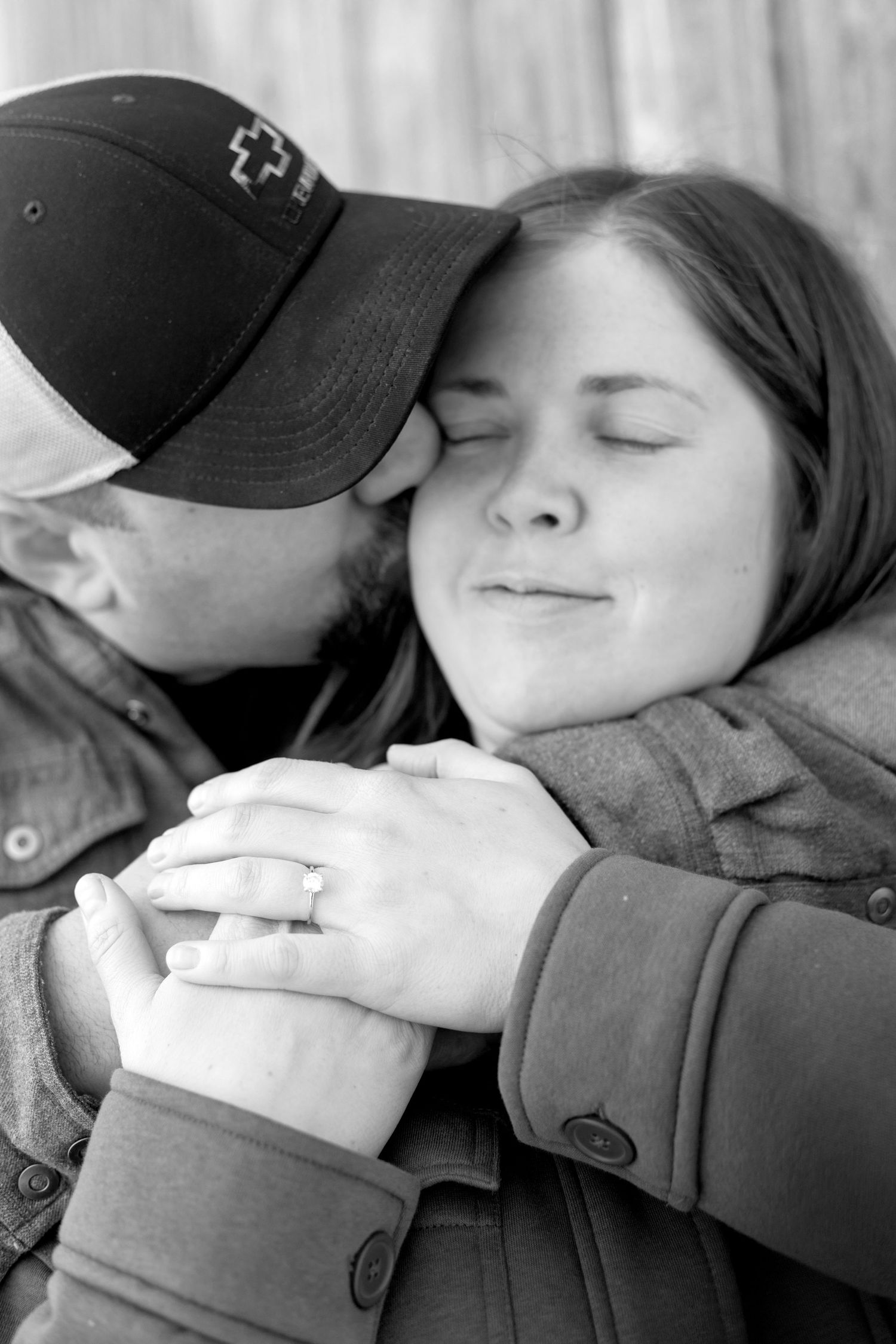 Black and white photo series showing a couple in a tender embrace with closed eyes and peaceful expressions.