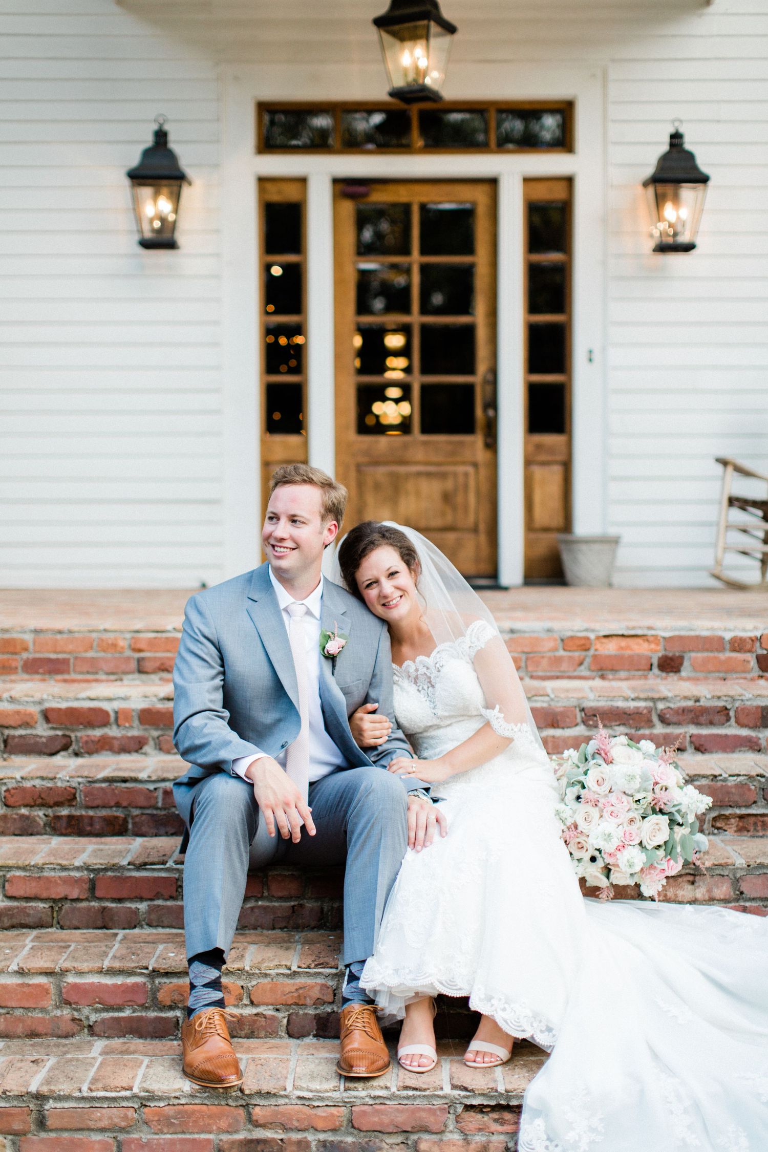bride and groom on porch at the carl house wedding venue
