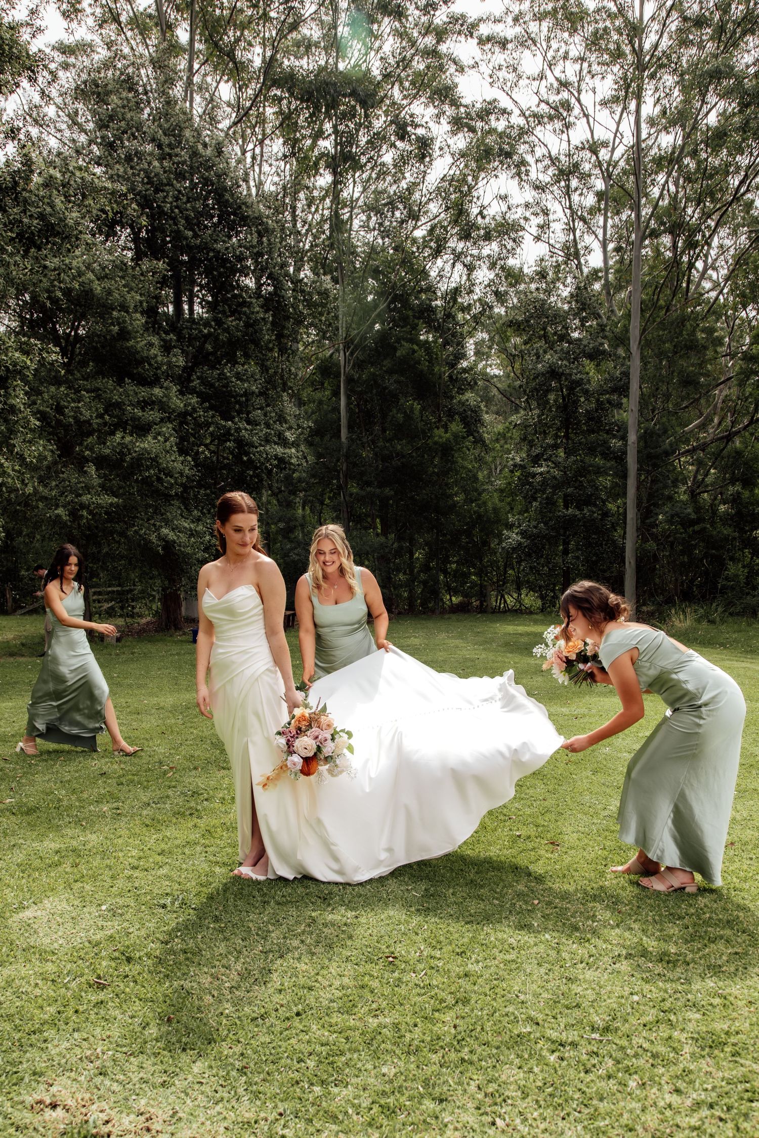 A playful sequence shows a wedding party having fun posing with a flowing white dress on a grassy lawn.