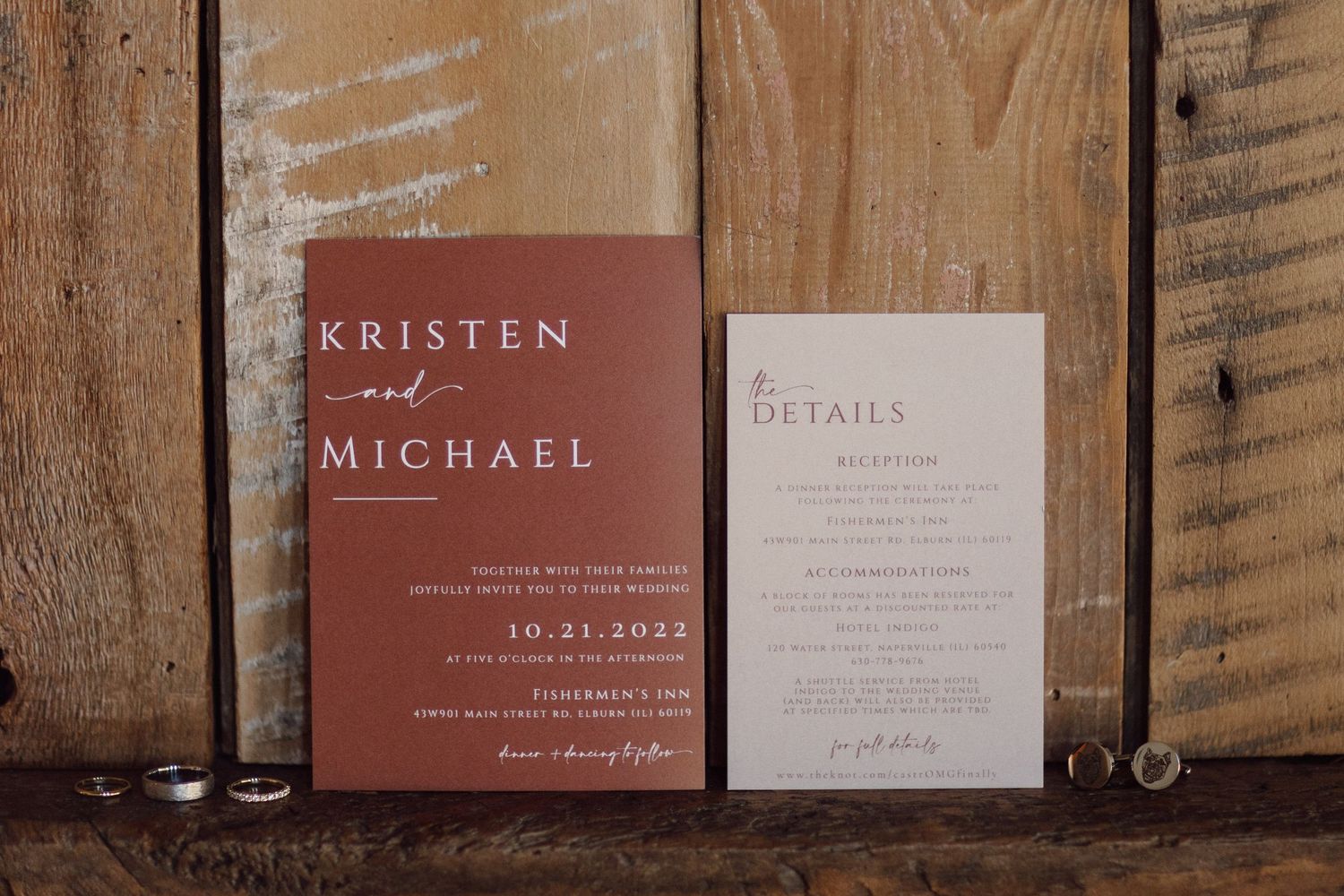 Wedding invitation suite in burgundy and white with wooden background.