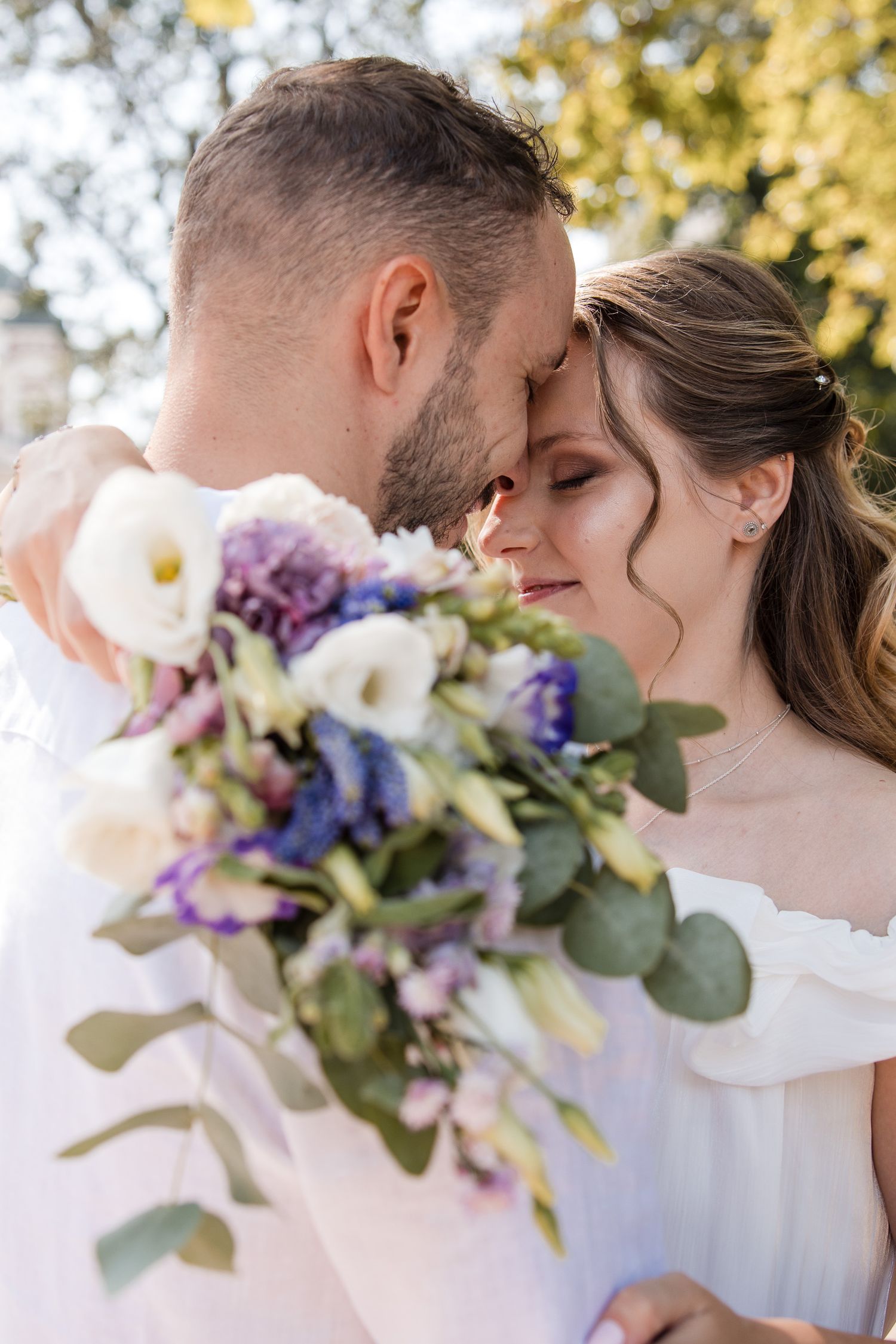 Intimate wedding portrait – romantic couple embrace captured by wedding photographer Avelim.
