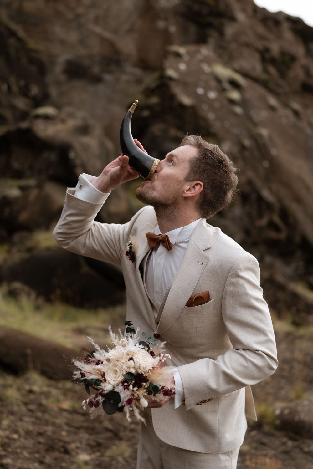 Groom drinking from a traditional Icelandic horn by Kleifarvatn Lake