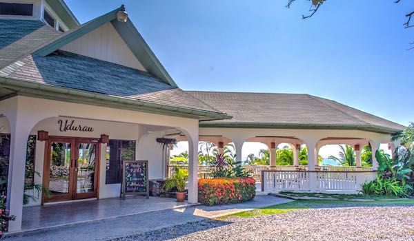 Caribbean-style resort entrance with covered walkway and tropical landscaping.
