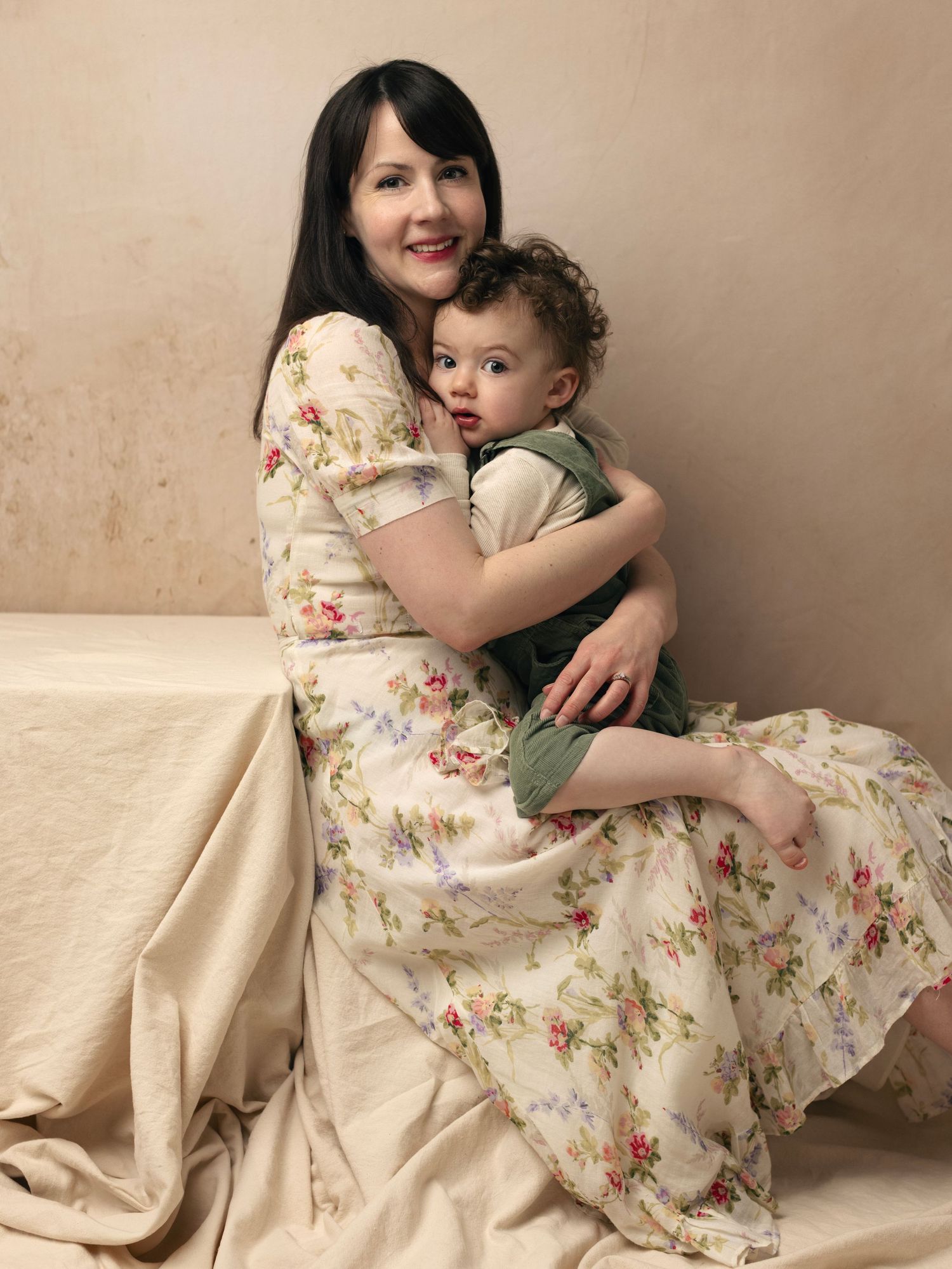 A heartwarming series of photos showing tender moments between a parent and child in matching floral dresses.