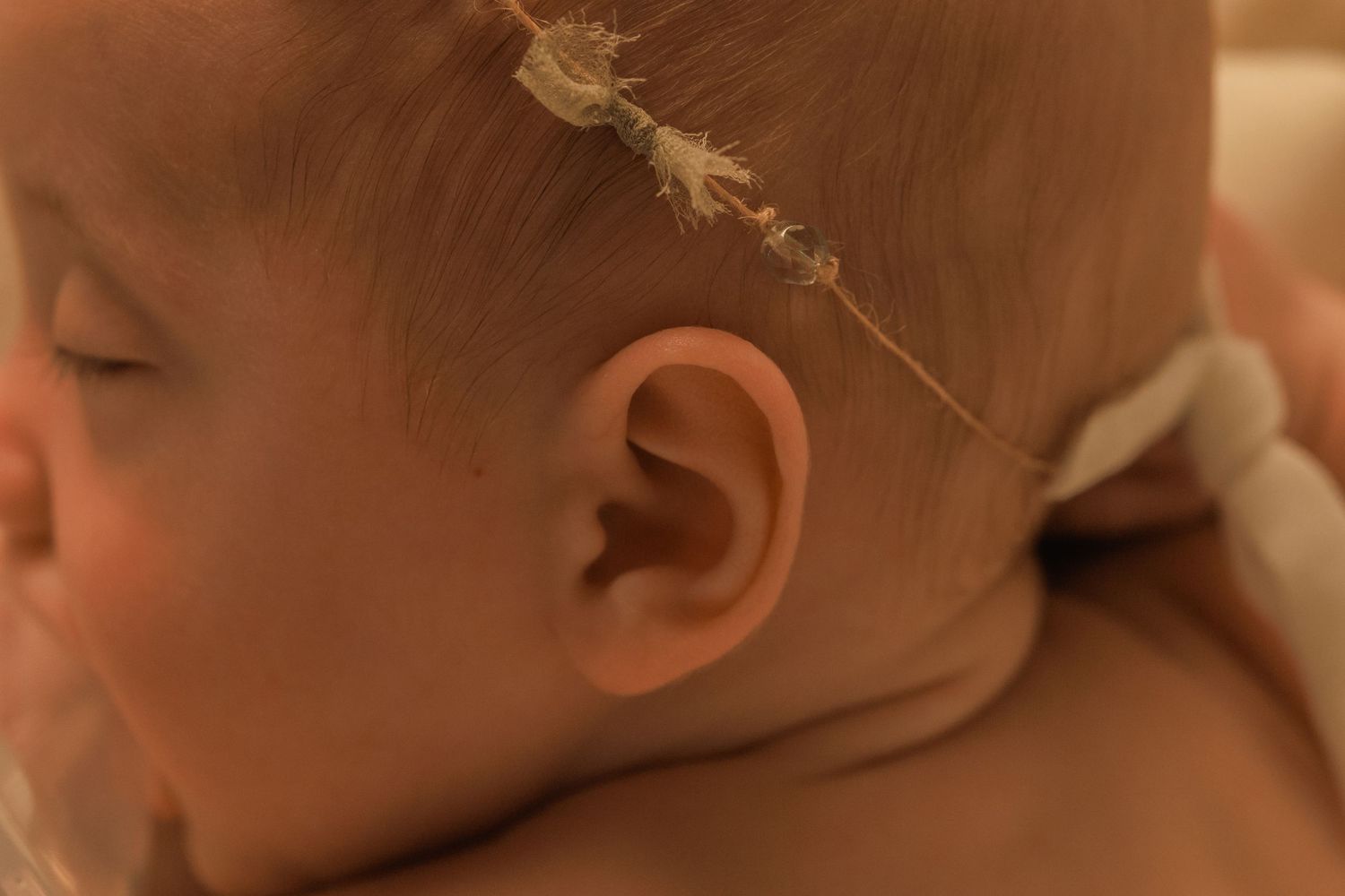 A row of close-up photos showing a baby's different facial expressions and emotions.