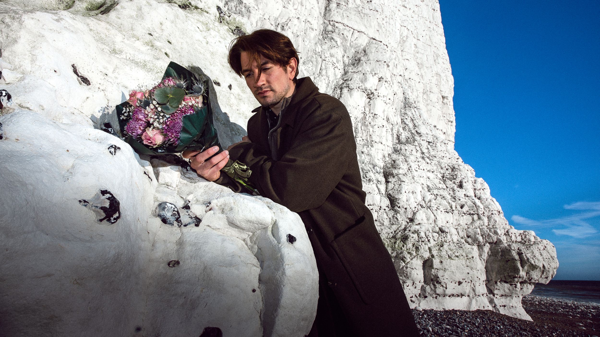 Action shots captured against bright white cliffs and blue sky on a sunny day.