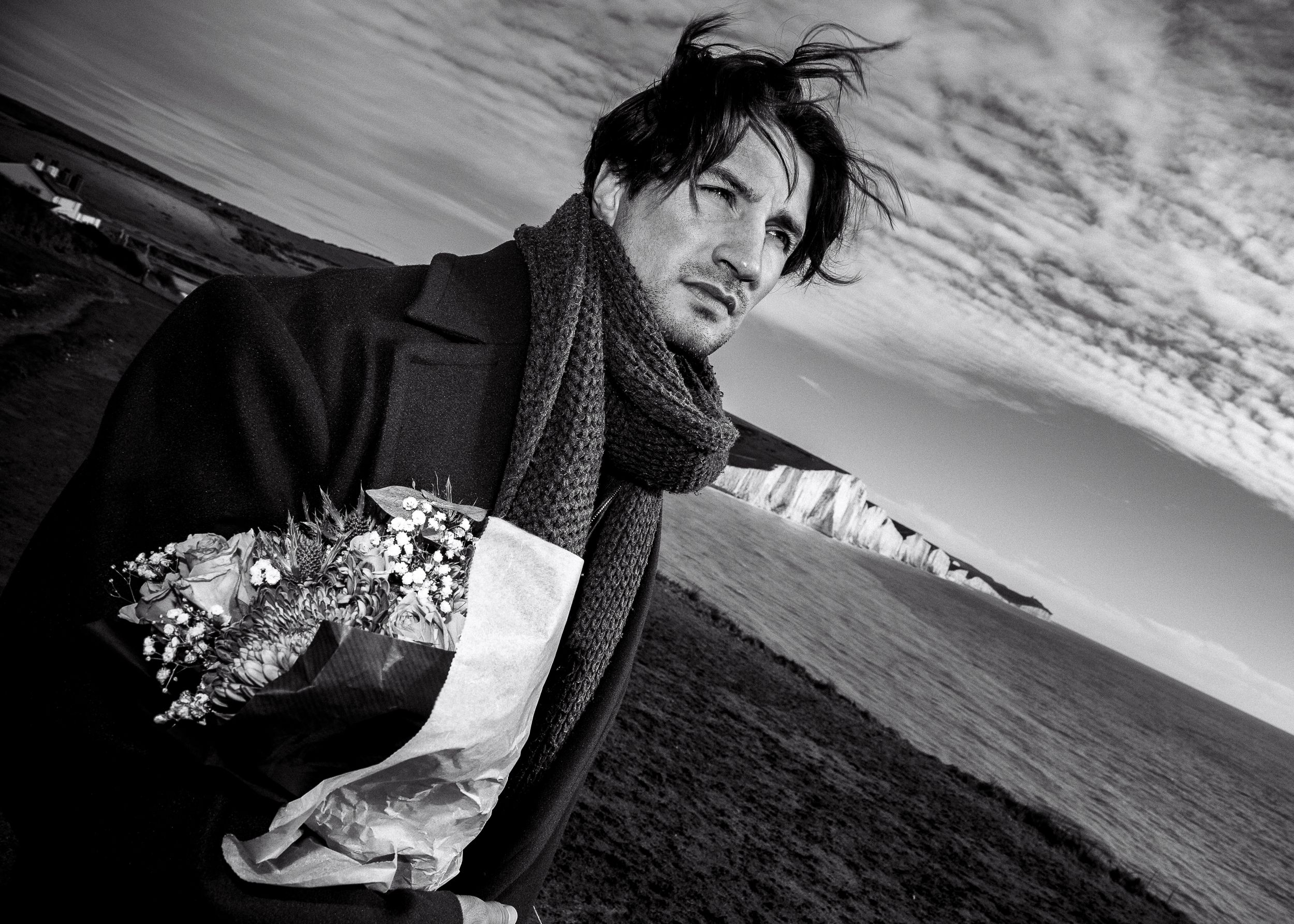 A dramatic black and white panoramic series showing a moody coastal landscape with dark clouds and stormy atmosphere.