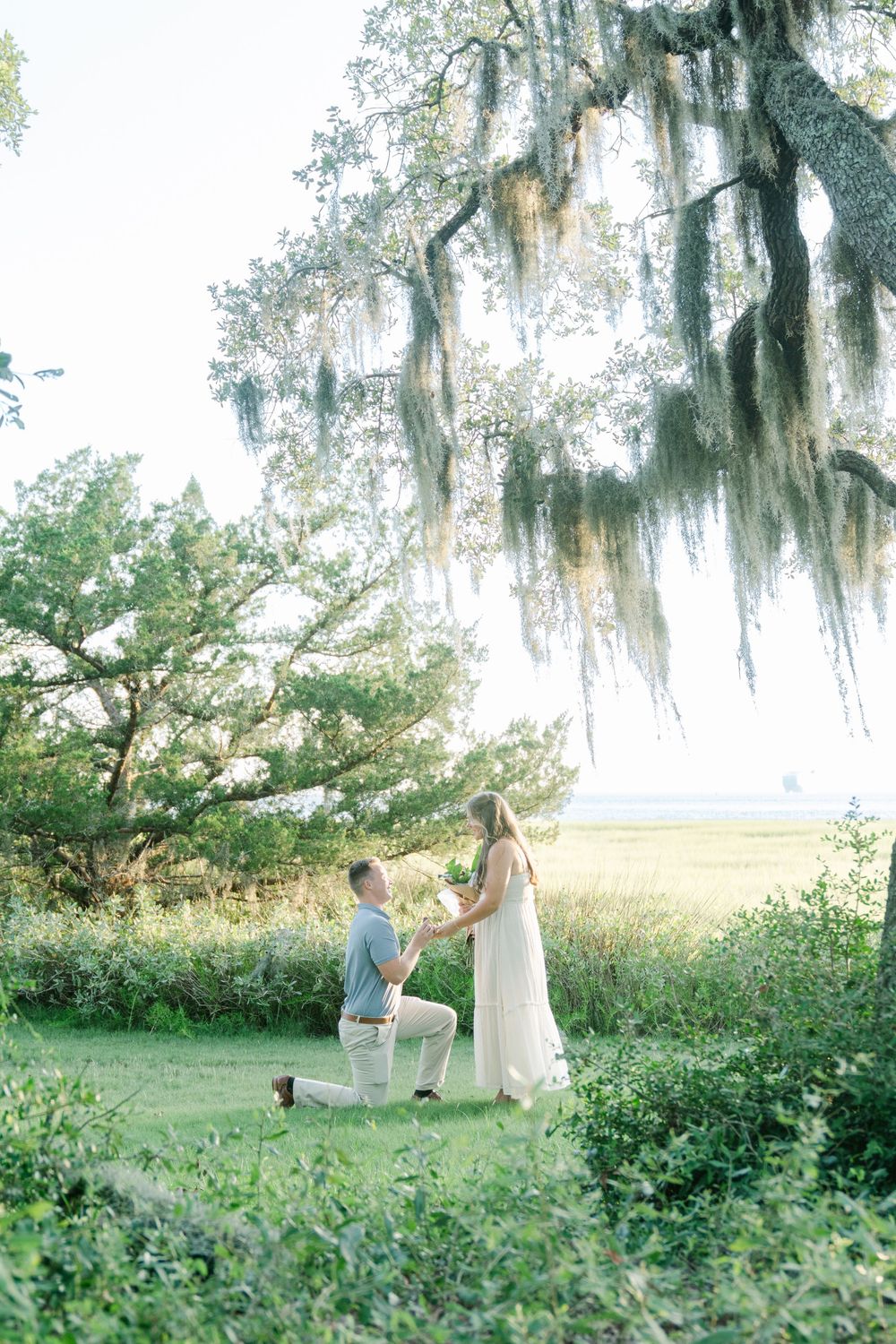 Emotional proposal moment captured at Clam Creek on Jekyll Island with marsh views in the Golden Isles.