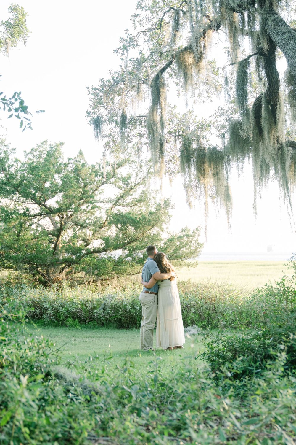 Justin surprises Caitlin with a proposal at Clam Creek on Jekyll Island overlooking the coastal Georgia marsh.