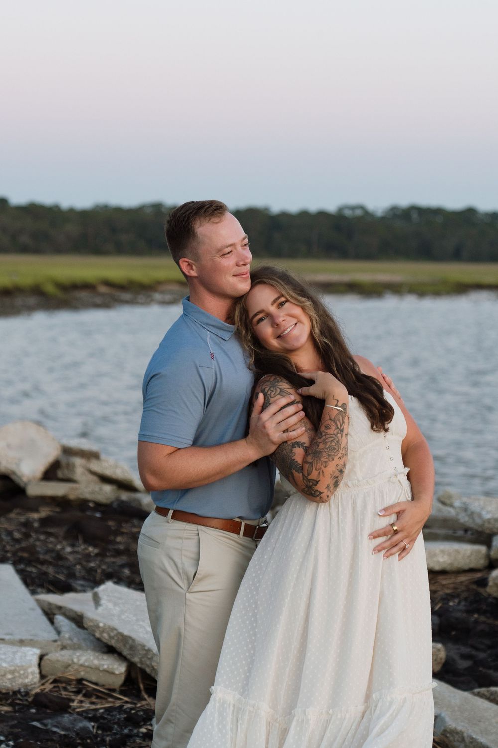 Natural portraits of expectant mother-to-be during maternity portraits with beautiful sunset near the Sidney Lanier bridge from Jekyll Is.