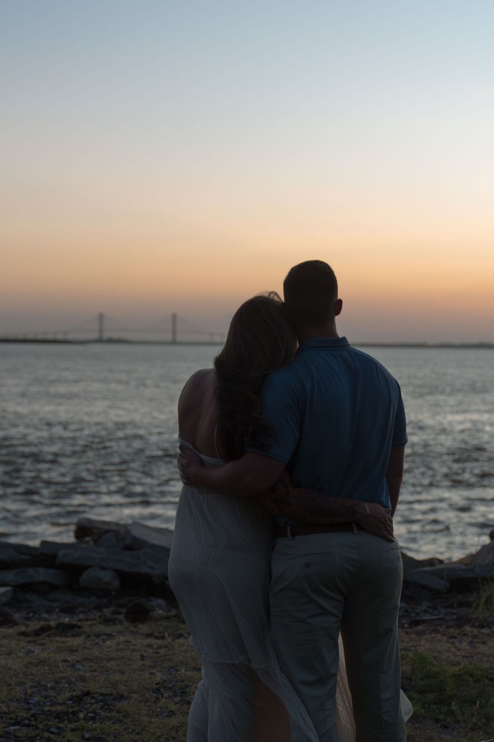 Natural portraits of expectant mother-to-be during maternity portraits with beautiful sunset near the Sidney Lanier bridge of Brunswick, GA