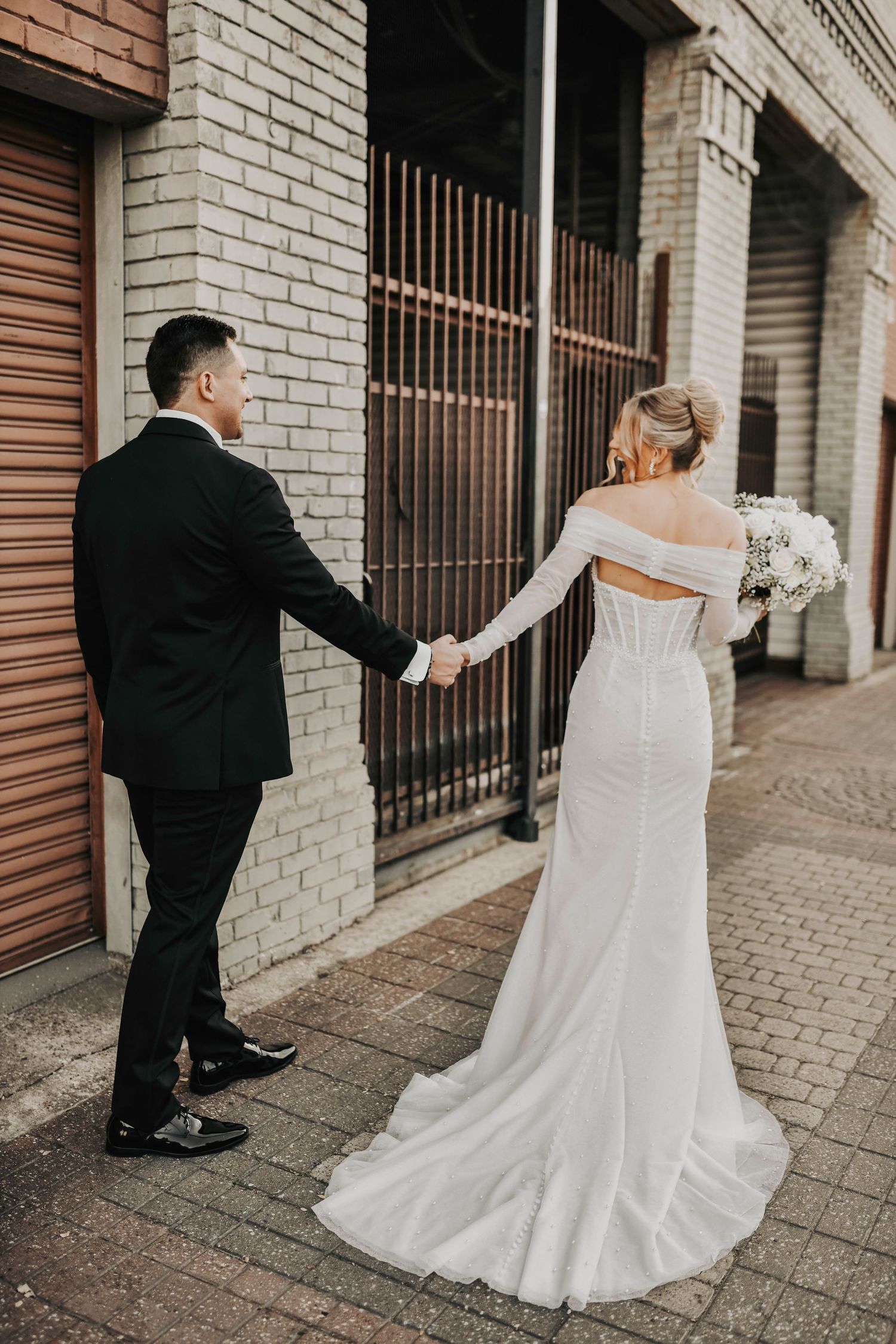 Bride and groom walking hand in hand as husband and wife