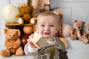 A collection of six photos showing a child in a striped outfit posing with teddy bears and holiday decor.