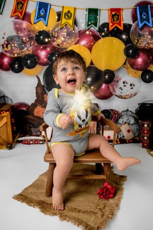 Colorful birthday party setup with balloons, banners, and burlap decorations for a festive celebration.
