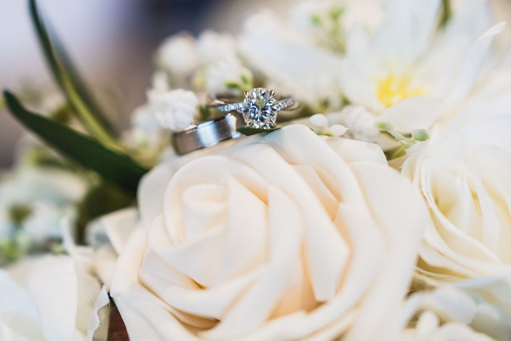 Close-up of delicate white roses and floral arrangements from wedding decor.