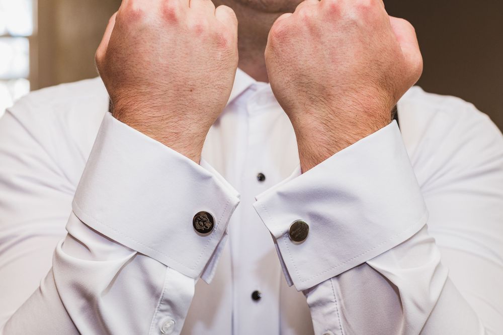 Detail shots of white dress shirts with black button accents.